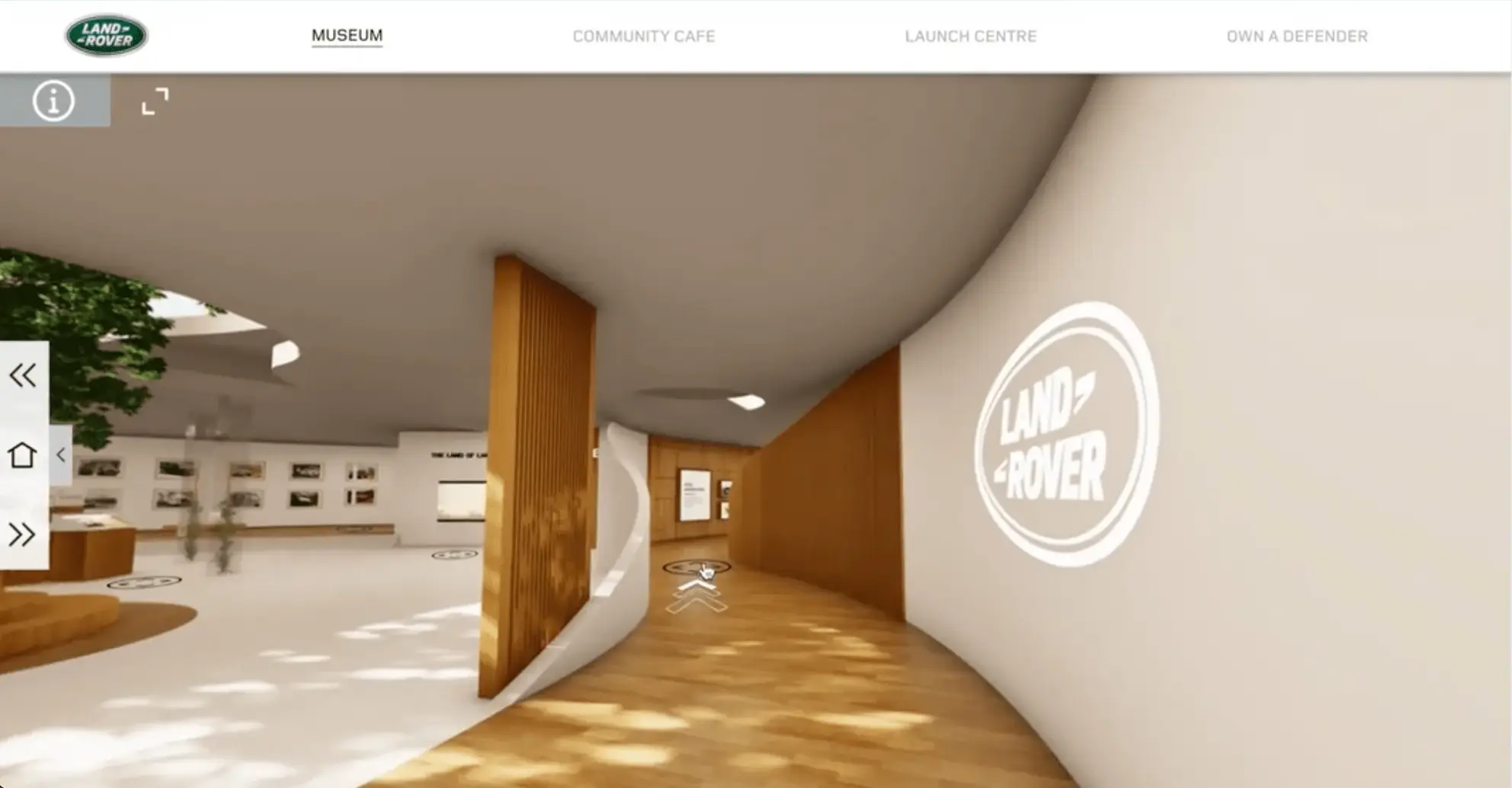 A curved, wood-lined museum corridor leading past a large Land Rover logo