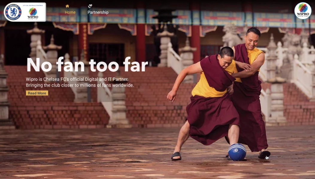 The No Fan Too Far homepage: two monks playing football in a temple courtyard, with the Chelsea and Wipro partnership logos