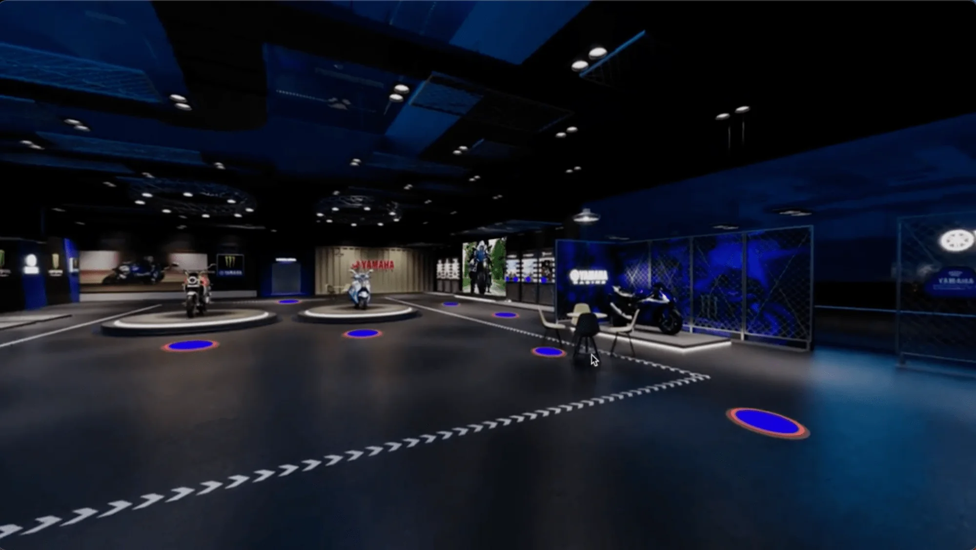 The showroom floor: motorcycles on turntables, a lounge area and blue hotspots marking where visitors can move